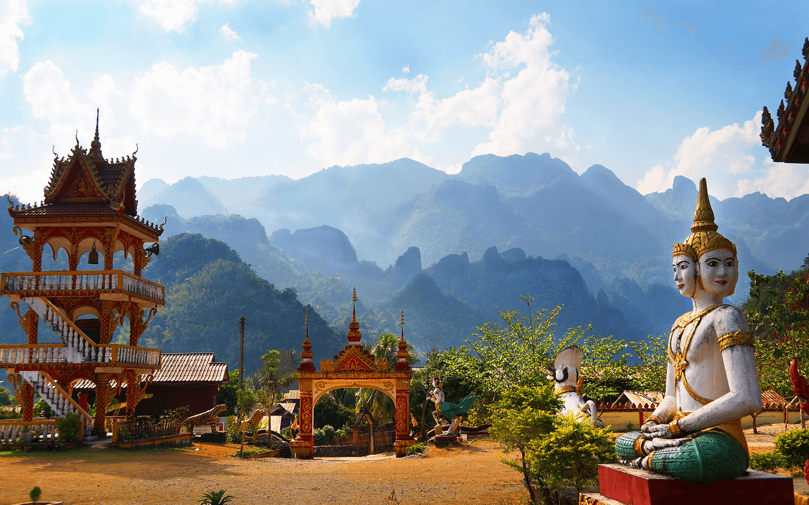View of a Buddhist statue and buildings in the mountains
